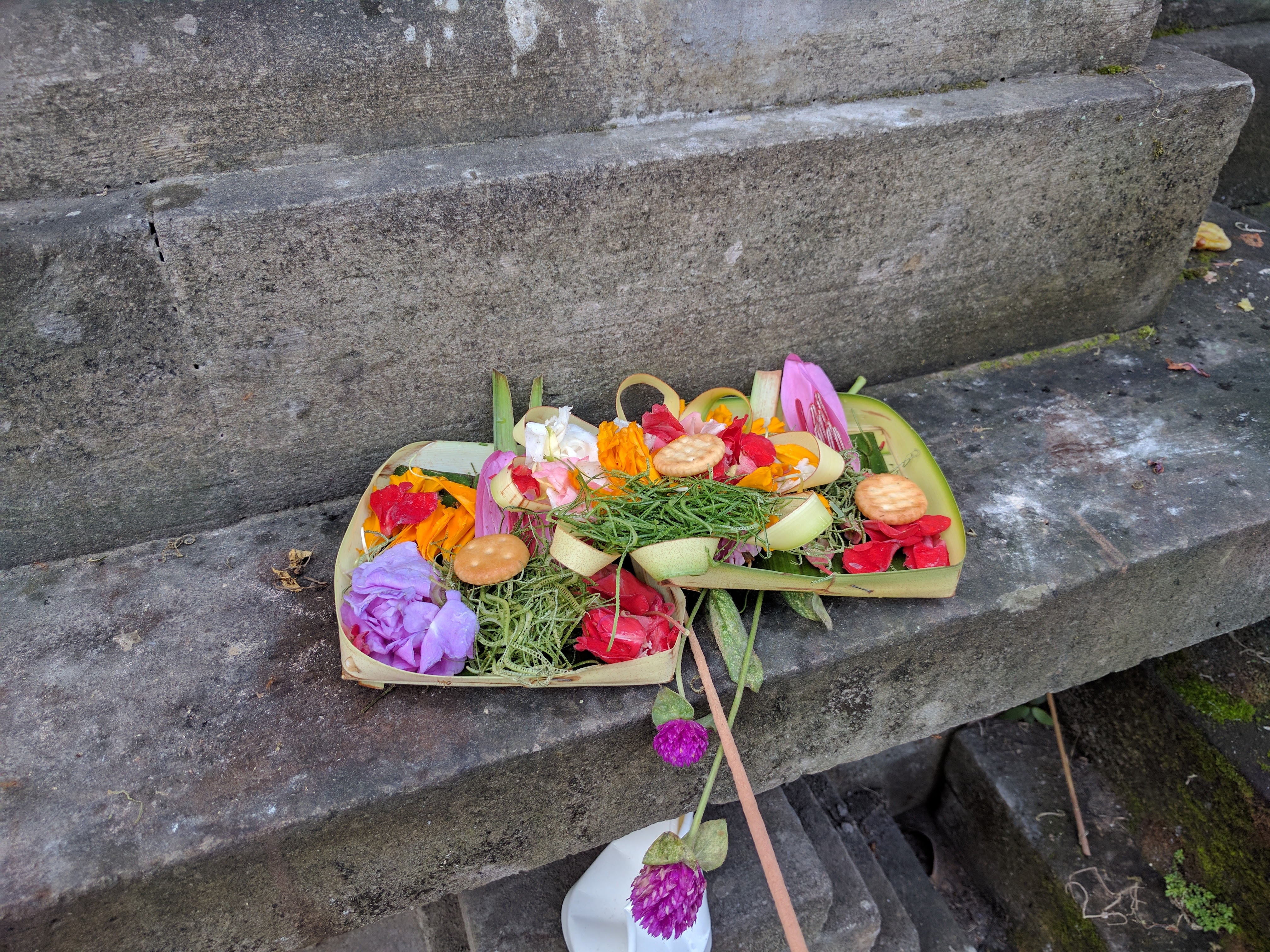 Canang Sari offerings made of palm tree leaves, flowers, fruits and crackers