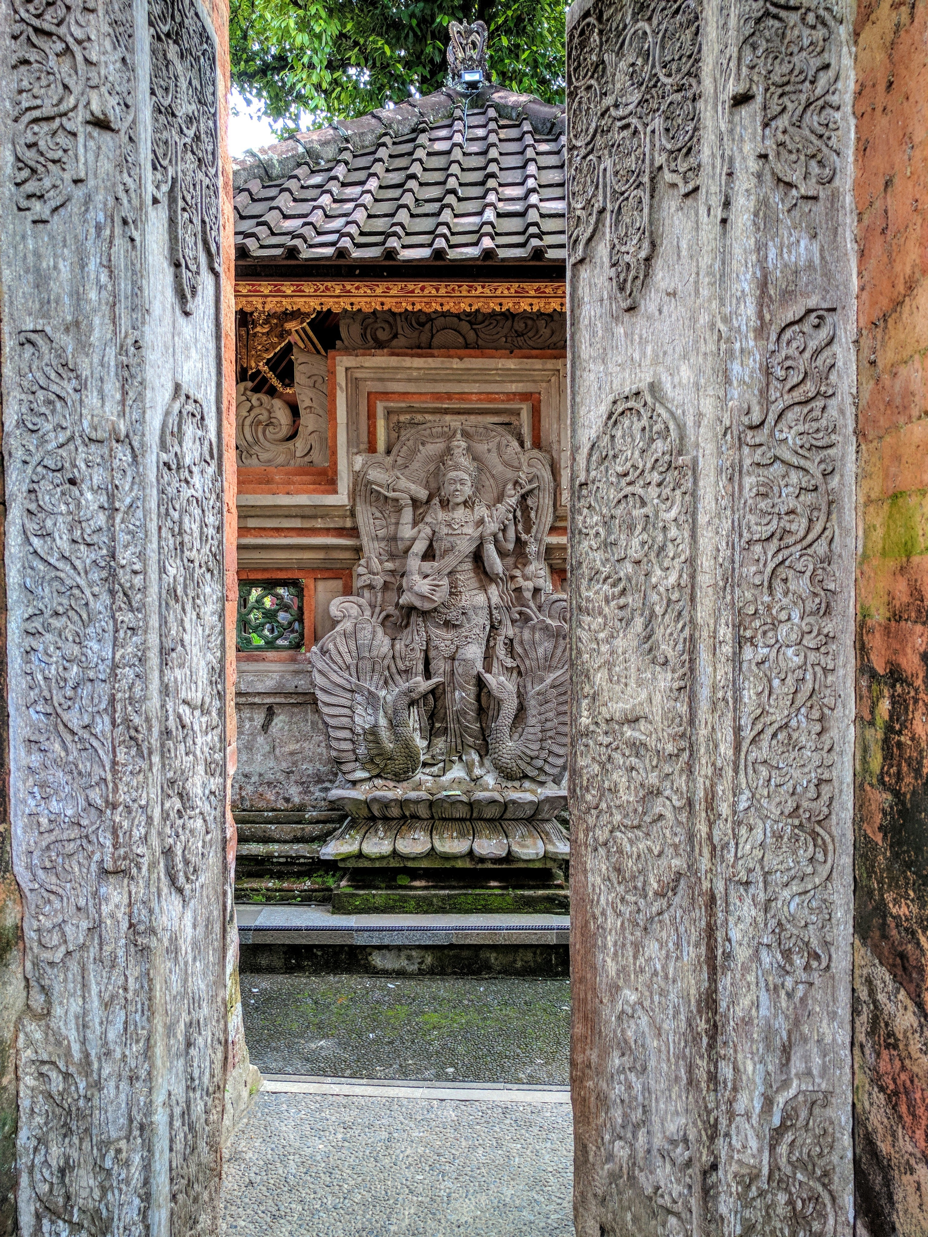 intricately carved temple door made out of wood in Bali Indonesia